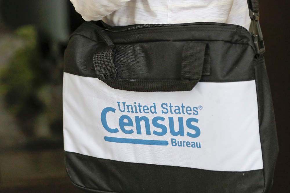 The U.S. Census Bureau's logo is featured on a black bag carried by a census worker knocking on doors in 2020 in Winter Park, Florida. (AP)