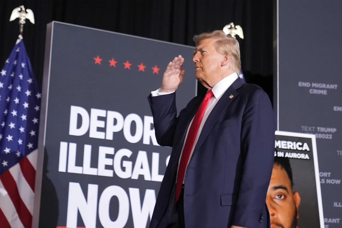 Republican presidential nominee Donald Trump salutes in Aurora, Colo., on Oct. 11. At that rally and others, he spoke of using a centuries-old act to expedite deportation of certain undocumented migrants.