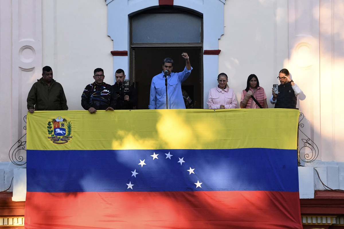 Venezuelan President Nicolas Maduro speaks next to First Lady Cilia Flores and Vice President Delcy Rodriguez during a rally at the Miraflores presidential palace in Caracas on July 30, 2024.