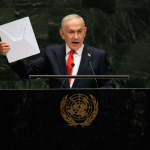 Israeli Prime Minister Benjamin Netanyahu holds up a Starlink satellite internet dish.