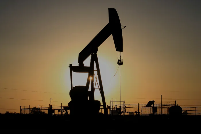A pump jack operates at sunset in the Permian Basin near Loving, N.M., on Tuesday, May 20, 2025.