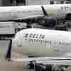 U.S. airline regulators have opened an investigation into Delta Air Lines, which is still struggling to restore operations on Tuesday, more than four full days after a faulty software update caused technological havoc worldwide and disrupted global air travel. Here, a Delta Air Lines plane leaves the gate on July 12, 2021, at Logan International Airport in Boston.