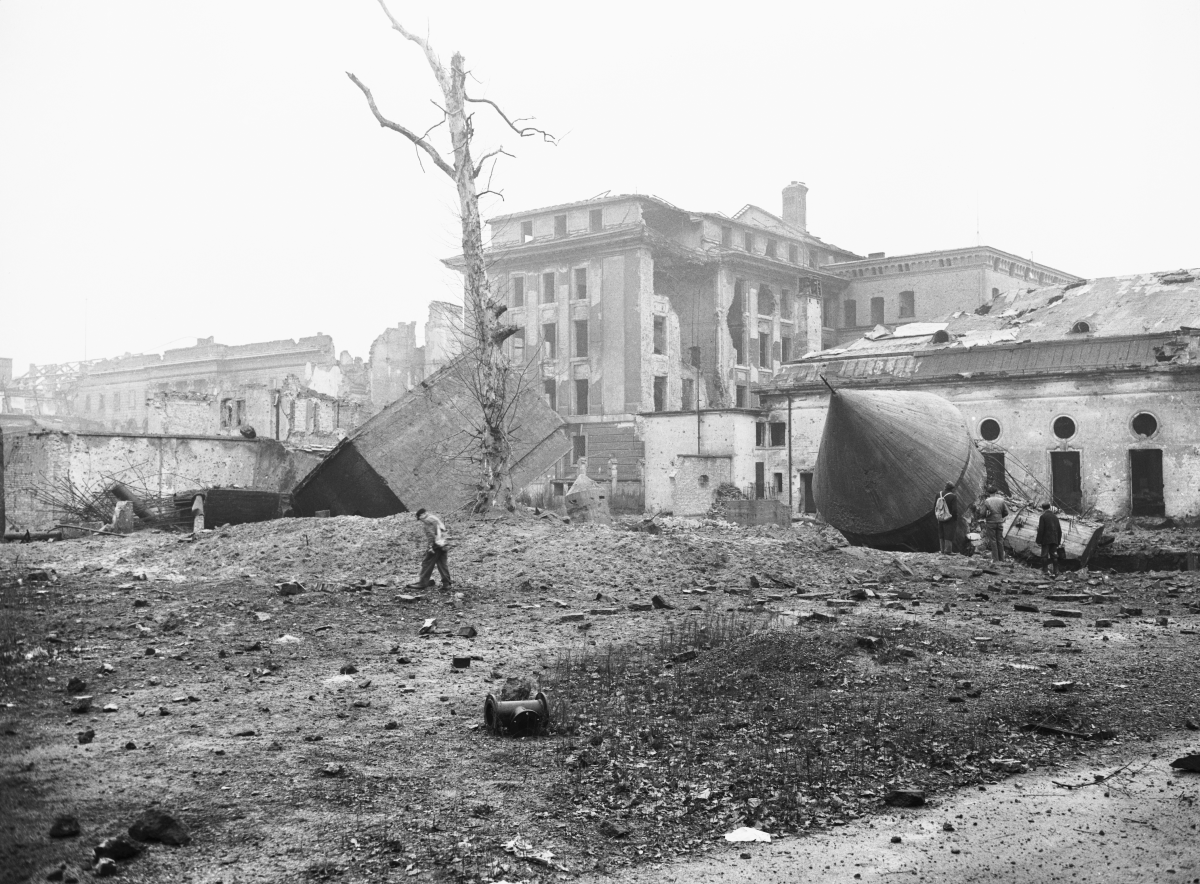 Sightseers walk amid the ruins of Hitler's air raid shelter in the 1940s.
