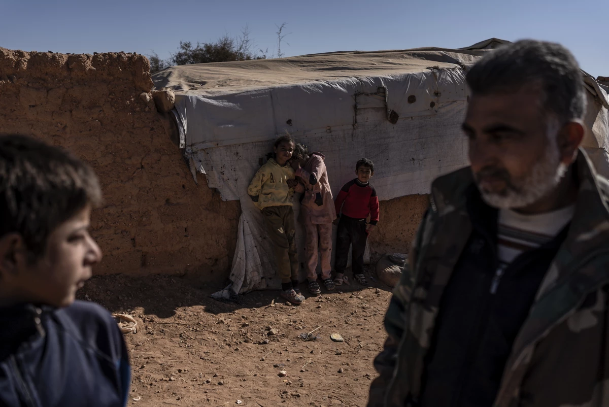 Displaced Syrian children and a man at the Rukban camp. More than 7,000 people have taken shelter there, many of them fleeing ISIS.