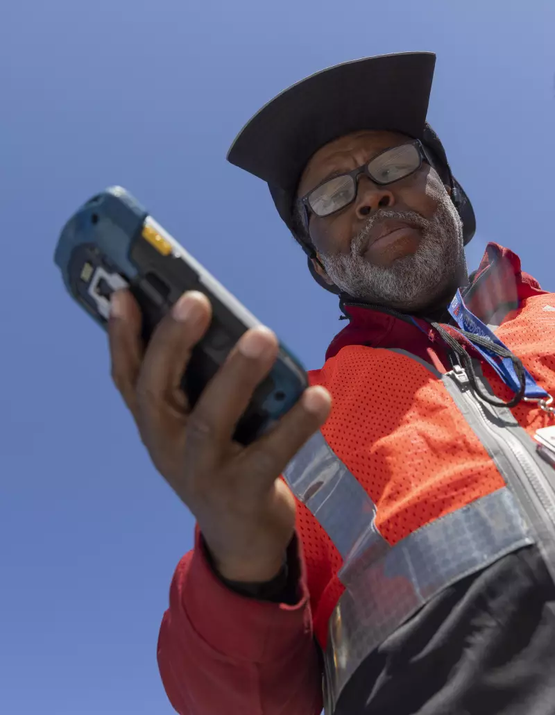 Delta Air Lines ramp agent Mike Davis uses a handheld electronic scanner with Delta Air Lines Radio Frequency Identification and Artificial Intelligence technology to locate passenger luggage on the tarmac at Atlanta Hartsfield Jackson International Airport in Atlanta, Georgia, May 13, 2026. 