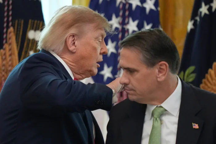 President Donald Trump walks past Attorney General Todd Blanche after speaking at a roundtable event in the East Room of the White House, Wednesday, Oct. 21, 2026, in Washington.