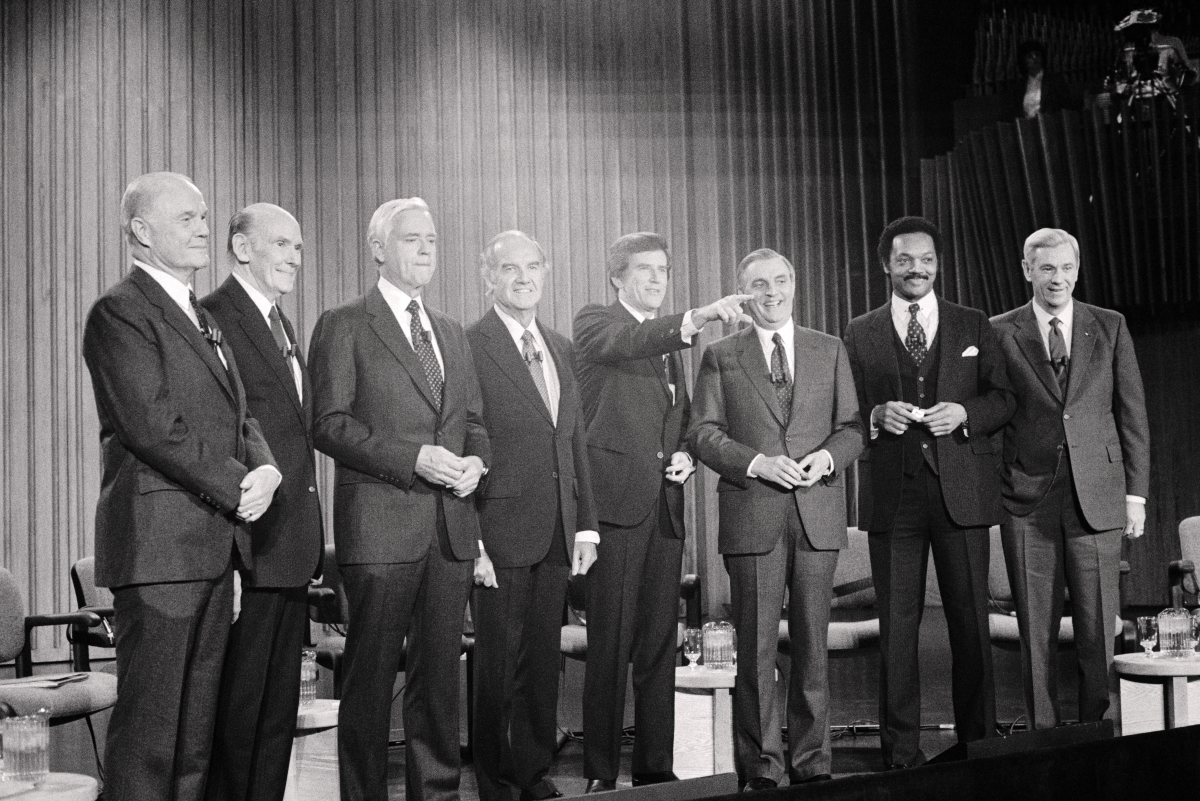 The 1984 Democratic Presidential candidates pose for photographers prior to the Democratic debate at Darmouth College. (left to right) John Glenn, Alan Cranston, Ernest Hollings, George McGovern, Gary Hart, Walter Mondale, Jesse Jackson, and Reubin Askew.