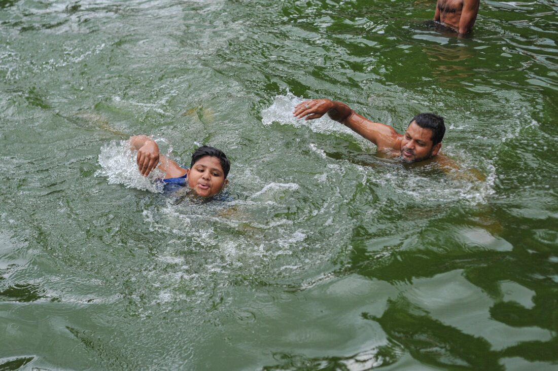 SYLHET, BANGLADESH: A father teaches his child to swim in a pond in Sylhet, Bangladesh. Drowning is one of the leading causes of death globally for children and young people aged 1 to 24 years. Every year, an estimated 236,000 people drown.