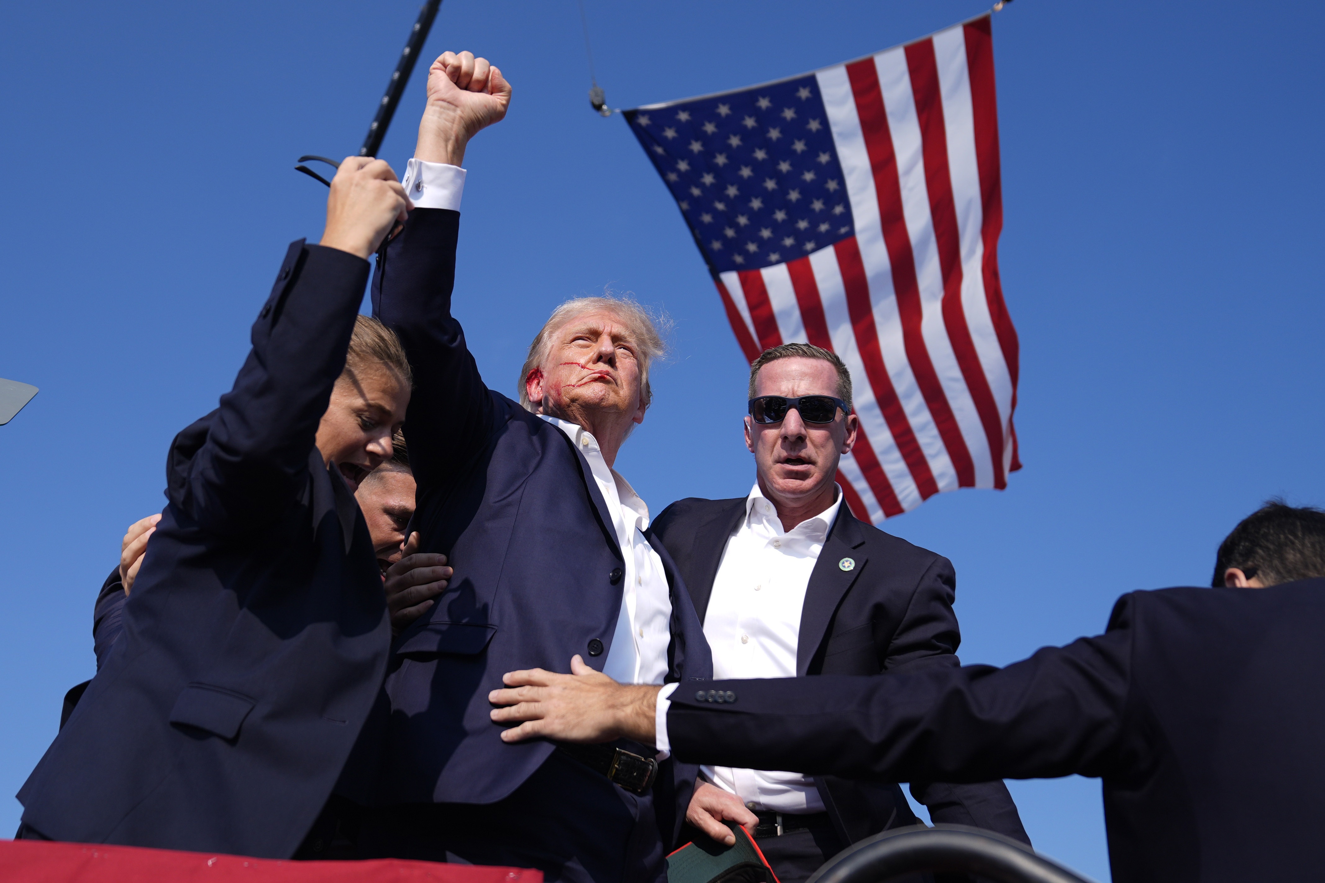 Former President Donald Trump is rushed offstage during a rally in Butler, Pa., after an assassination attempt on his life.