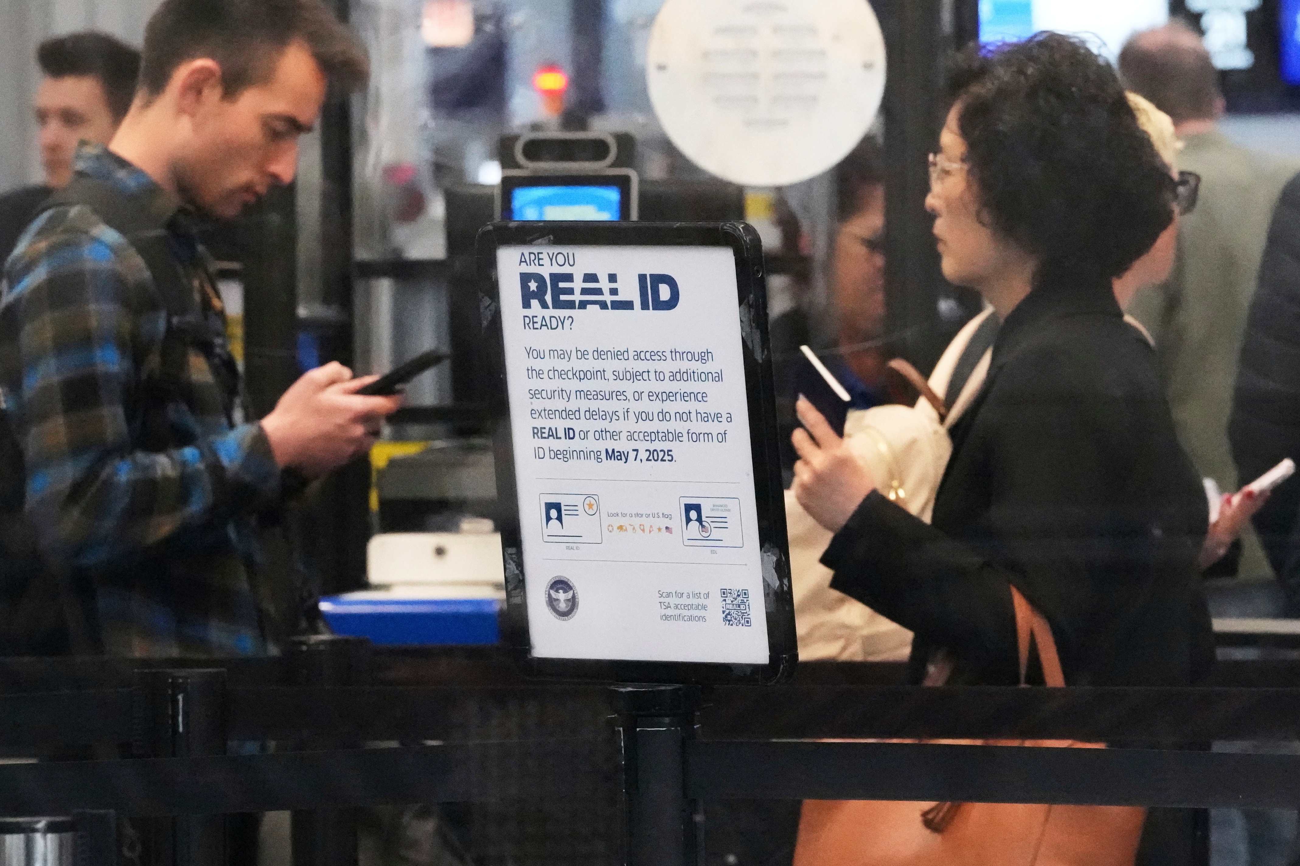 A Real ID sign is displayed as travelers wait to go through security check point at O'Hare International Airport in Chicago, May 23, 2025. (AP)