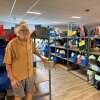 "Maine Needs" volunteer Lee Cooper stands near bags of filled orders, ready for providers to pick up for clients