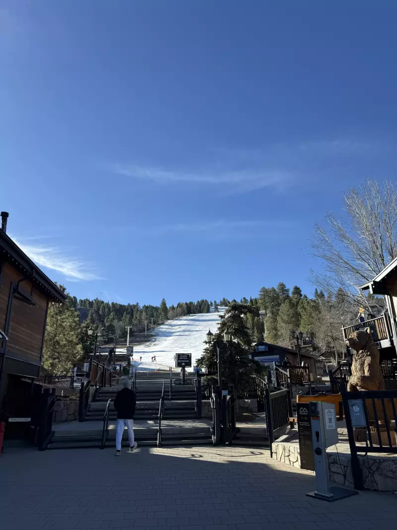 Viewed from the base area, an intermediate slope at Snow Summit Resort in Big Bear, Calif., has sparse snow coverage during a warm winter.