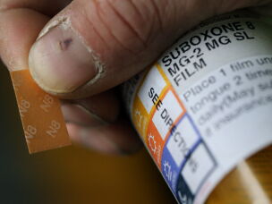 A patient displays his Suboxone prescription following his appointment at the substance use disorders Bridge Clinic at Massachusetts General Hospital in Boston on April 27, 2018. The patient takes Suboxone, a medicine that contains buprenorphine and naloxone, to treat his substance use disorder.