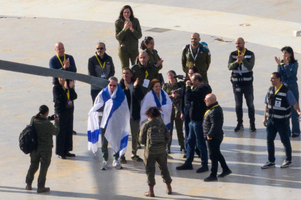 Released hostage Ohad Ben Ami draped in an Israeli flag arrives at Tel Aviv Sourasky Medical Center - Ichilov Hospital by helicopter, on Feb. 8, in Tel Aviv, Israel.