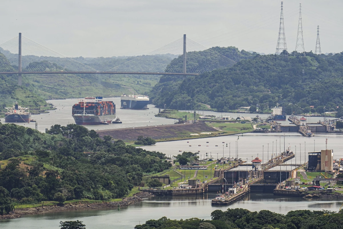 A cargo ship navigates through the Panama Canal, seen from the Cerro Ancon in Panama City.
