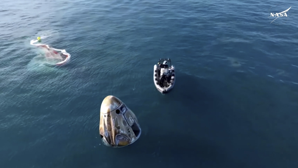 In this image taken from video provided by NASA, a SpaceX capsule floats in the Gulf of Mexico, Tuesday, March 18, 2025, after landing off the coast of Florida with NASA astronauts Suni Williams, Butch Wilmore and Nick Hague, and Russian cosmonaut Alexander Gorbunov. (NASA)