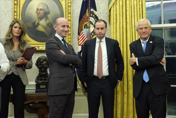 Lindsey Halligan stands next to other White House aides including Deputy Chief of Staff Stephen Miller and Staff Secretary Will Scharf as President Trump speaks with reporters in the Oval Office in February.
