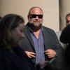 Right-wing conspiracy theorist Alex Jones stands outside the federal courthouse after a June bankruptcy hearing in Houston.
