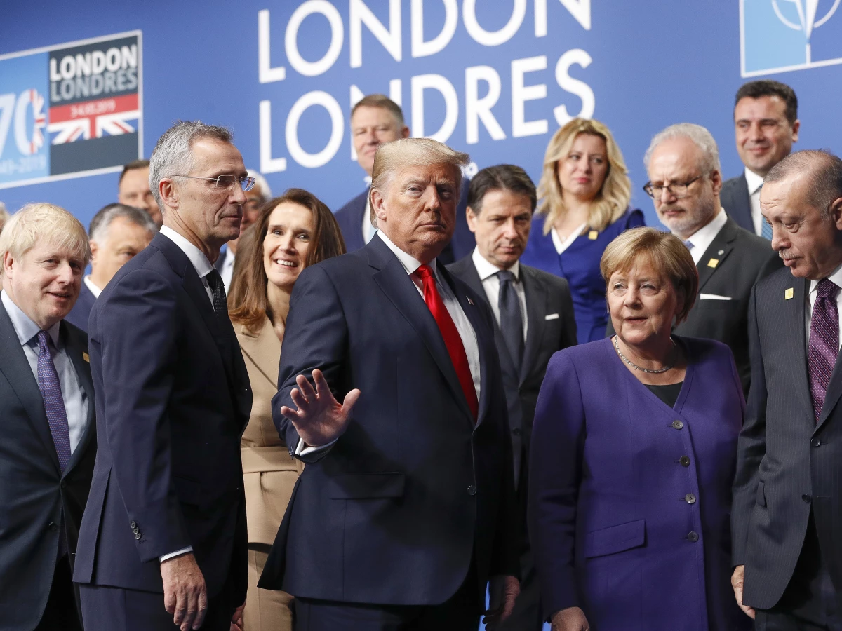 In this file photo, then-President Donald Trump, center, gestures as he walks off the podium after a group photo at a NATO leaders meeting in Watford, Hertfordshire, England on Dec. 4, 2019. Trump says he once warned that he would allow Russia to do whatever it wants to NATO member nations that are “delinquent” in devoting 2% of their gross domestic product to defense.