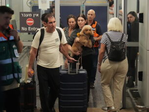 Passengers who experienced an emergency landing in Saudi Arabia during a flydubai flight arrive at Ben Gurion International Airport, near Tel Aviv, Israel, Wednesday.