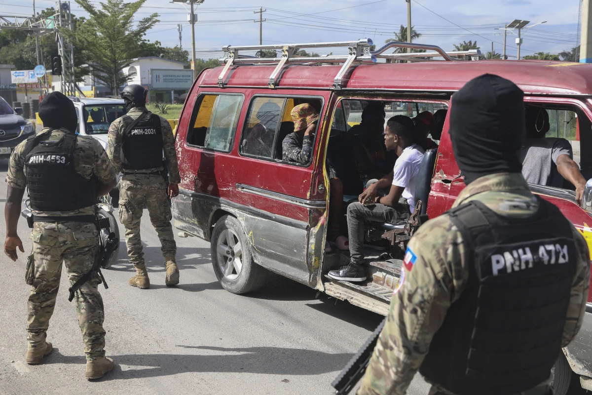 Police officers patrol near the Toussaint Louverture International Airport in Port-au-Prince, Haiti on Tuesday.