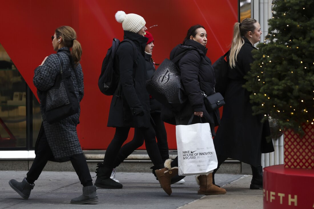 Shoppers walk along Fifth Avenue on Nov. 29 in New York City.