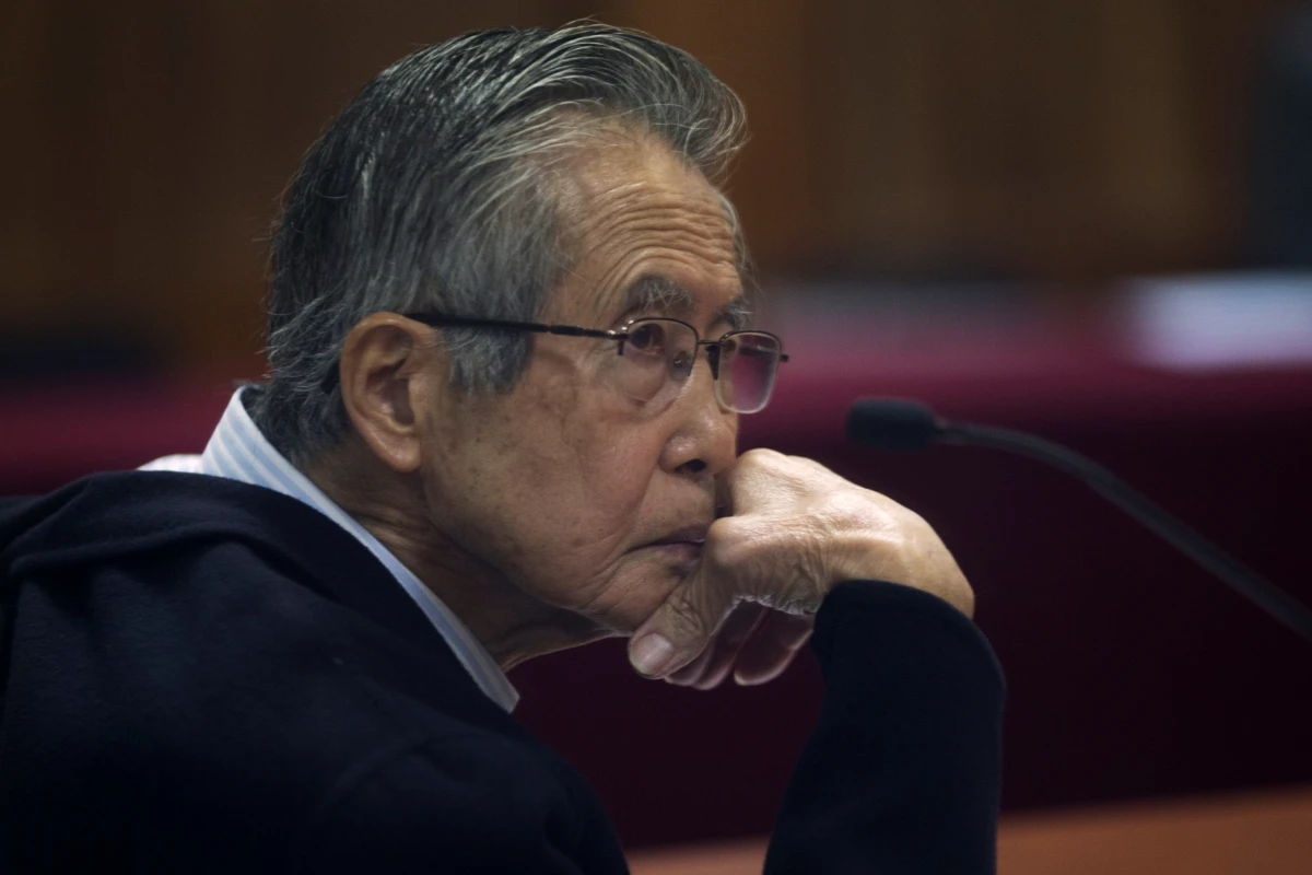 Peru's jailed former President Alberto Fujimori, photographed through a glass window, attends his trial at a police base on the outskirts of Lima, Peru, on June 28, 2016. His daughter Keiko Fujimori announced in a post on X that he died of cancer Wednesday.
