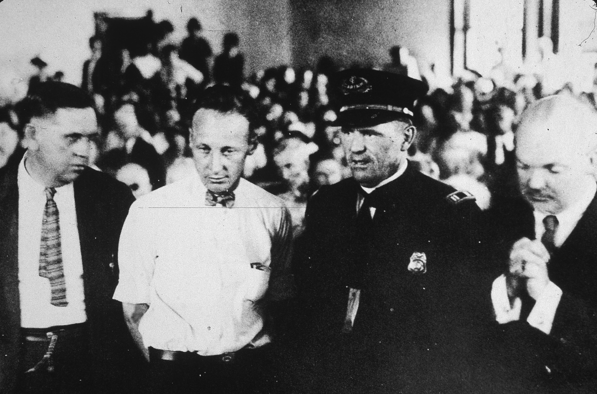 Teacher John Scopes, second from left, stands in the courtroom during his trial on charges of teaching Darwin's theory.