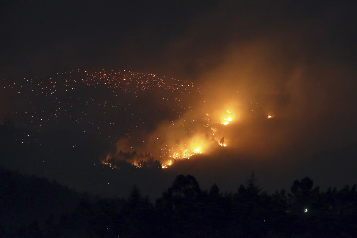 A fire burns on a hillside near Sever do Vouga, a town in northern Portugal that has been surrounded by forest fires, on Tuesday.