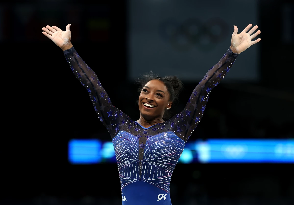Simone Biles reacts after the balance beam portion of the women's gymnastics individual all-around competition at the Paris Olympics on Thursday. She's now won six Olympic gold medals — the most of any U.S. gymnast.