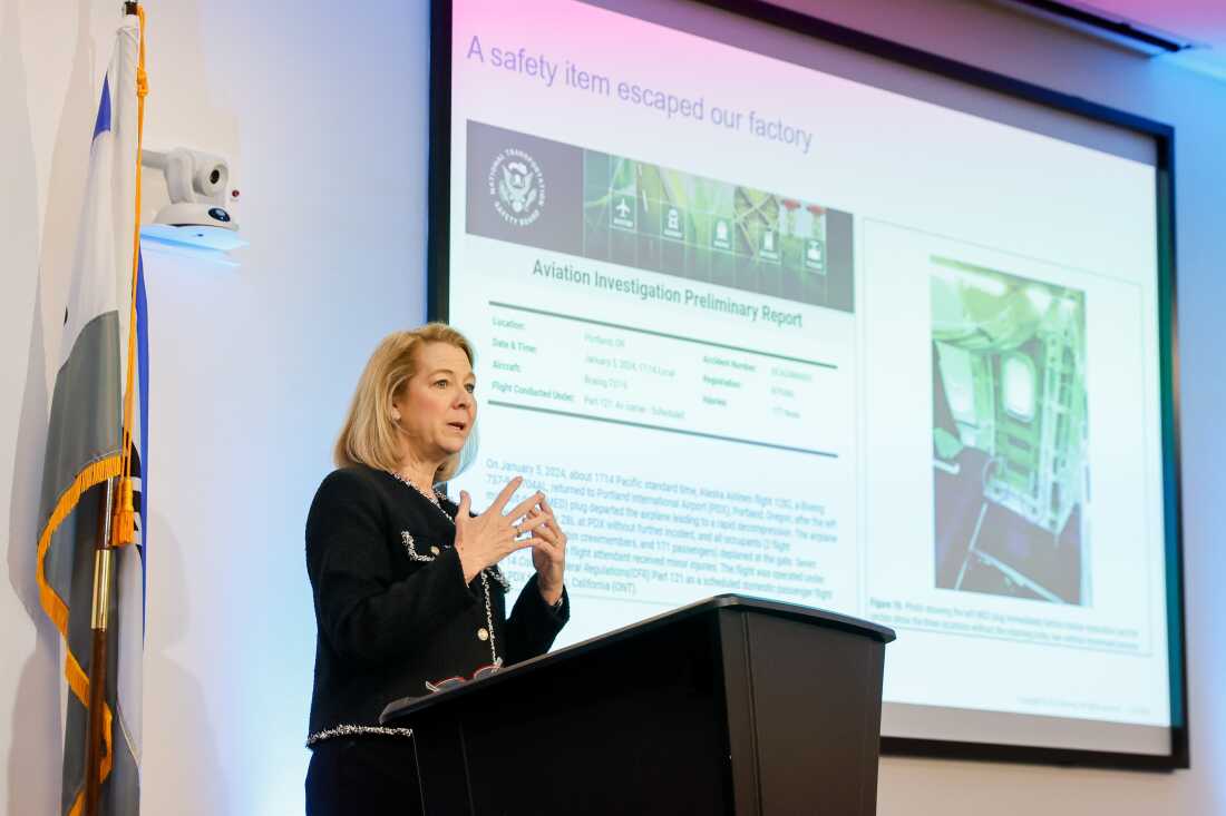 Elizabeth Lund, senior vice president of quality at Boeing, speaks to gathered media in front of a slide detailing the door plug blow-out that occurred on Jan. 5, 2024, on Alaska Airlines Flight 1282.