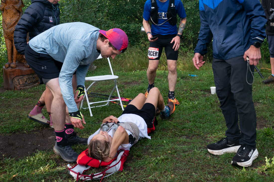 Gold medal-winning Olympian and Minnesotan Jessie Diggins rests on the ground with the support of her crew after crossing the finish line of the Superior 100 Mile Trail Race Saturday, Sept. 12, 2026 at Caribou Highlands Lodge in Lutsen, Minn.