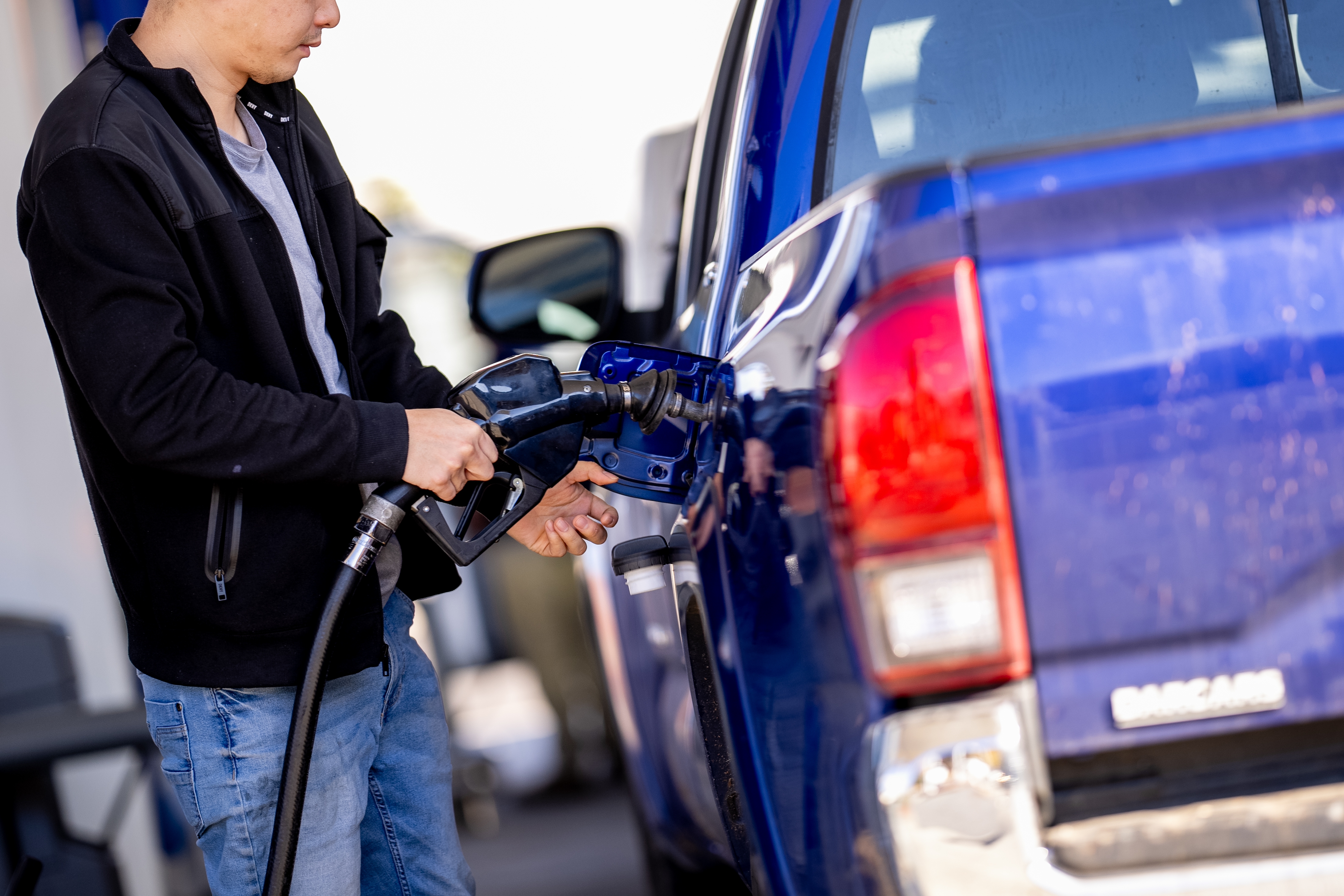 A man stops to fill up his car at a gas station in Washington, D.C., in November. Gas prices have fallen this spring, despite the fact that they typically rise this time of year, largely because of lower oil prices. That saves drivers money and also brings down the costs of goods.
