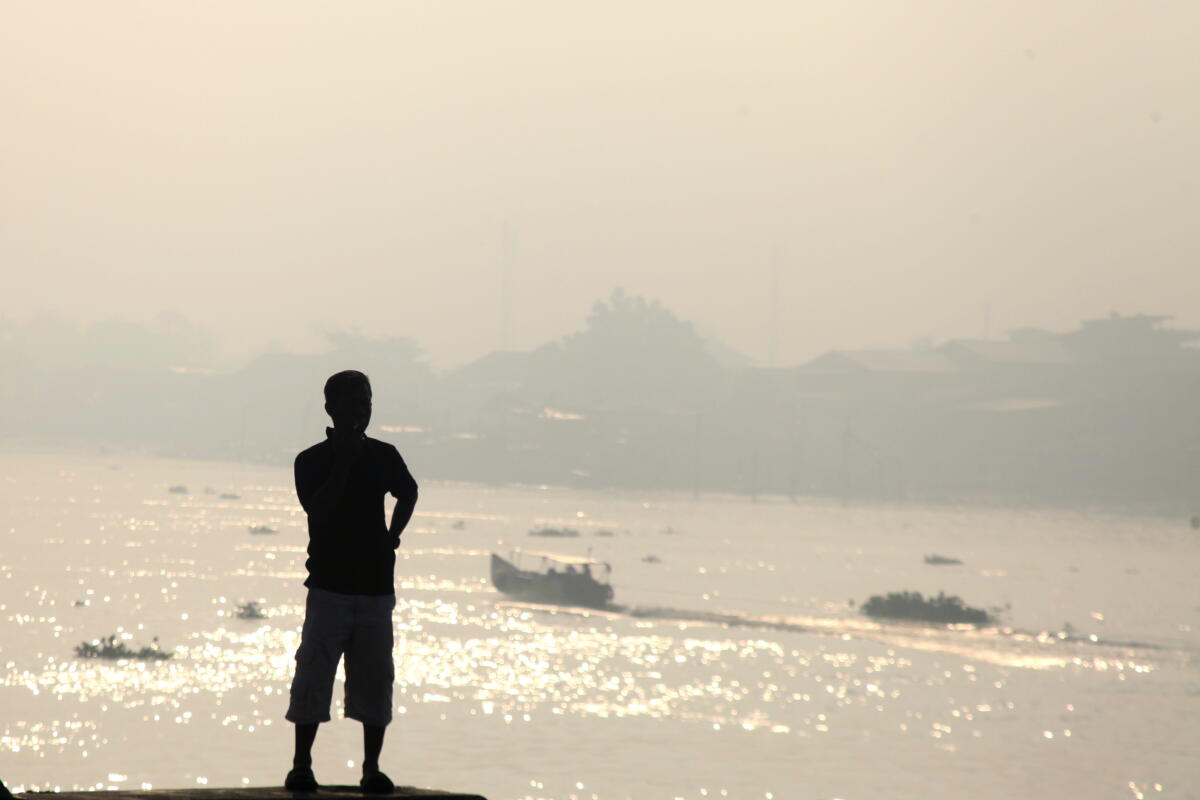 Indonesians brave choking smoke to pray for rain as country battles wildfires 1 A man is silhouetted against the haze from wildfires that blankets Musi River in Palembang, South Sumatra, Indonesia, Sunday, Aug. 23, 2026.