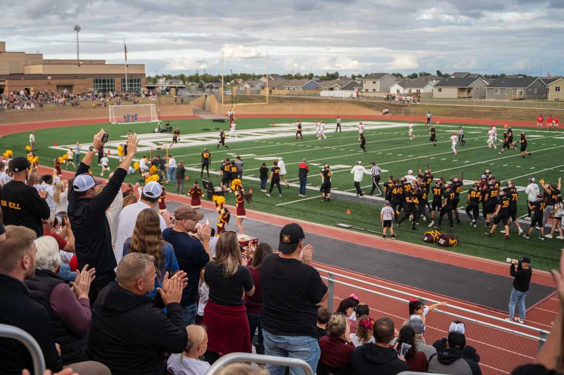 Harrisburg High School football fans cheer on the team in Harrisburg, South Dakota.