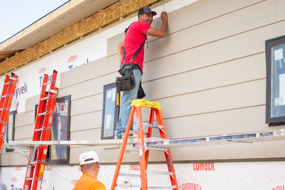 Teyon Fritzler installs paneling on a future therapeutic foster home. He sees the work as a chance to rebuild his community, which is within the Apsáalooke Nation, also known as the Crow Tribe.