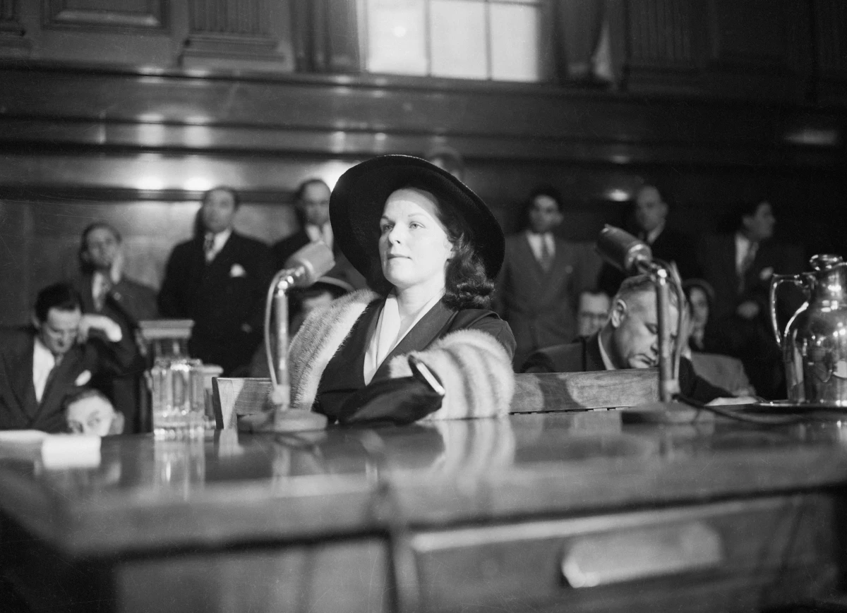 Wearing a mink stole, Virginia Hill Hauser testified before the Kefauver committee. She faced questions about her financial dealings with several key crime figures.