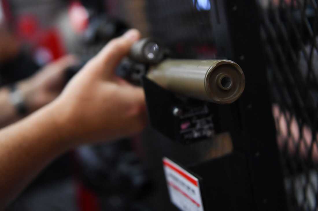 A SureFire firearm sound suppressor, commonly referred to as a silencer, is displayed during the National Rifle Association (NRA) Annual Meeting in Houston, Texas on May 28, 2022. A recent court ruling eased restrictions around the purchase of suppressors.