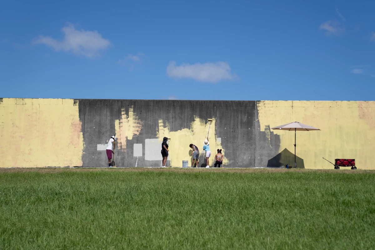 Teens with the Eternal Seeds art program begin a mural for the 20th anniversary of Katrina near the levee breach on the Industrial Canal in the Lower Ninth Ward. None of the members were alive when Katrina hit, they range between the ages of 15 to 18.