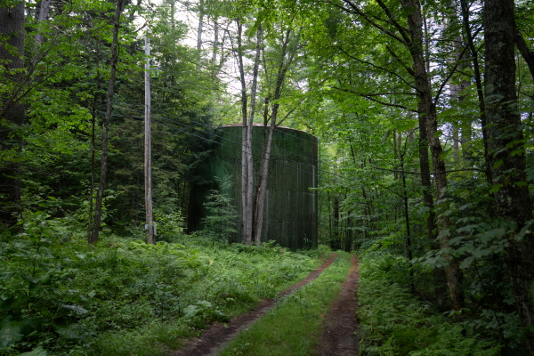 A large tank holds a reserve of drinking water in the woods near Cavendish.