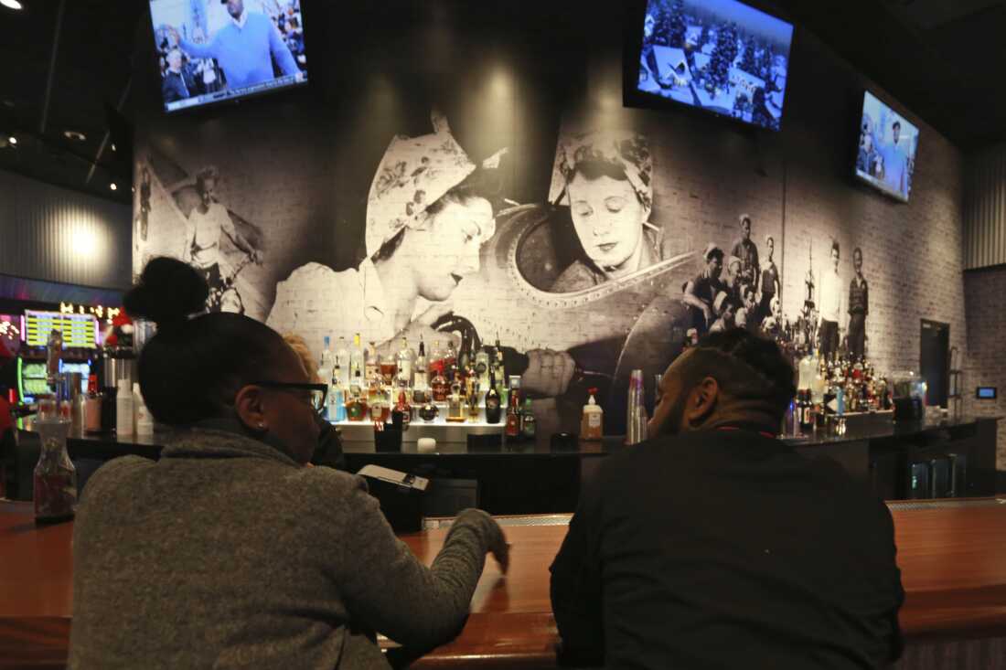 Anyone out enjoying a bar, at a party or a club are at a higher risk of drink spiking in those settings. In this Dec. 16, 2019 photo, patrons sit at the bar in Richmond, Va.