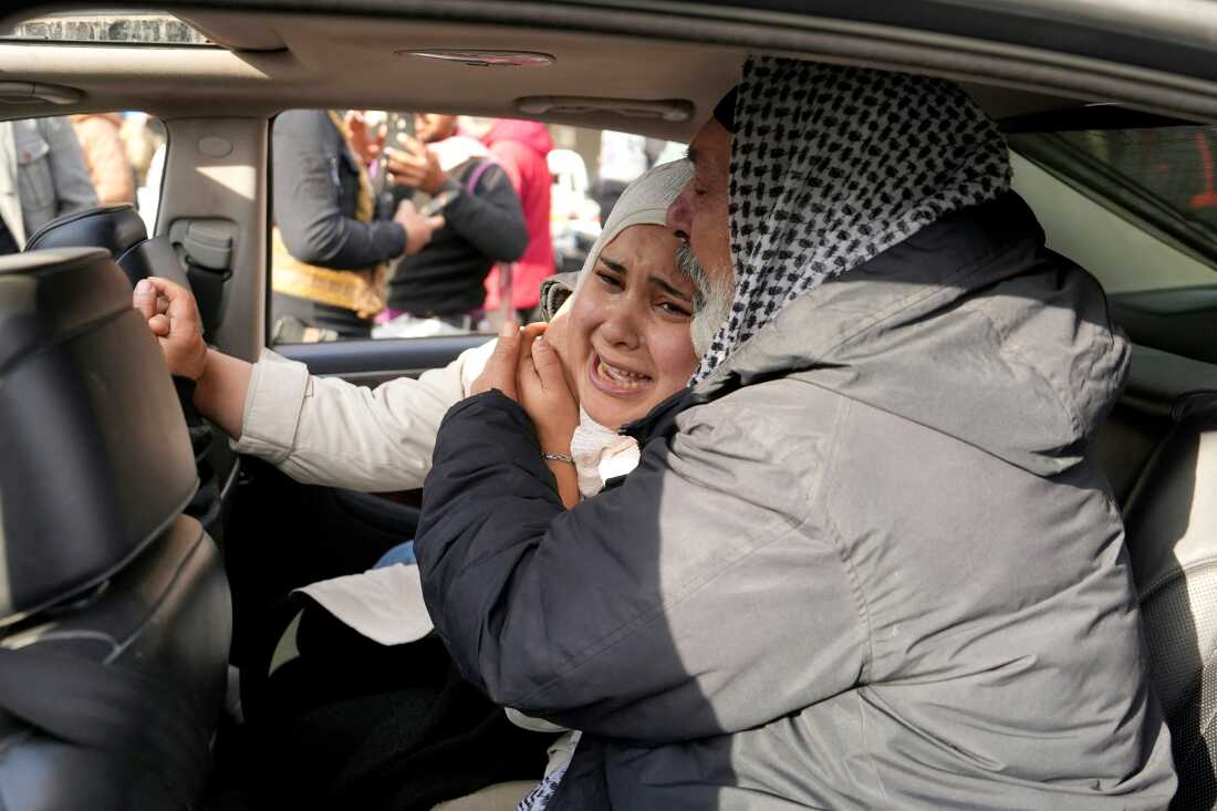 Displaced Syrians break into tears as they return to central city of Homs, after rebel forces entered Syria's third city overnight.