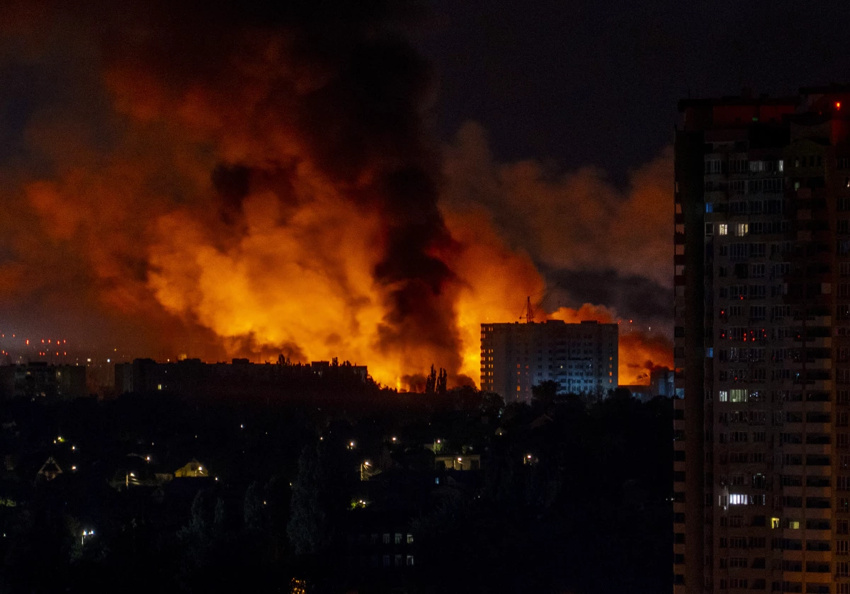 Flames and smoke billow from buildings during mass Russian drones and missile strikes on Ukraine's capital in July 2025, amid the Russian invasion of Ukraine.