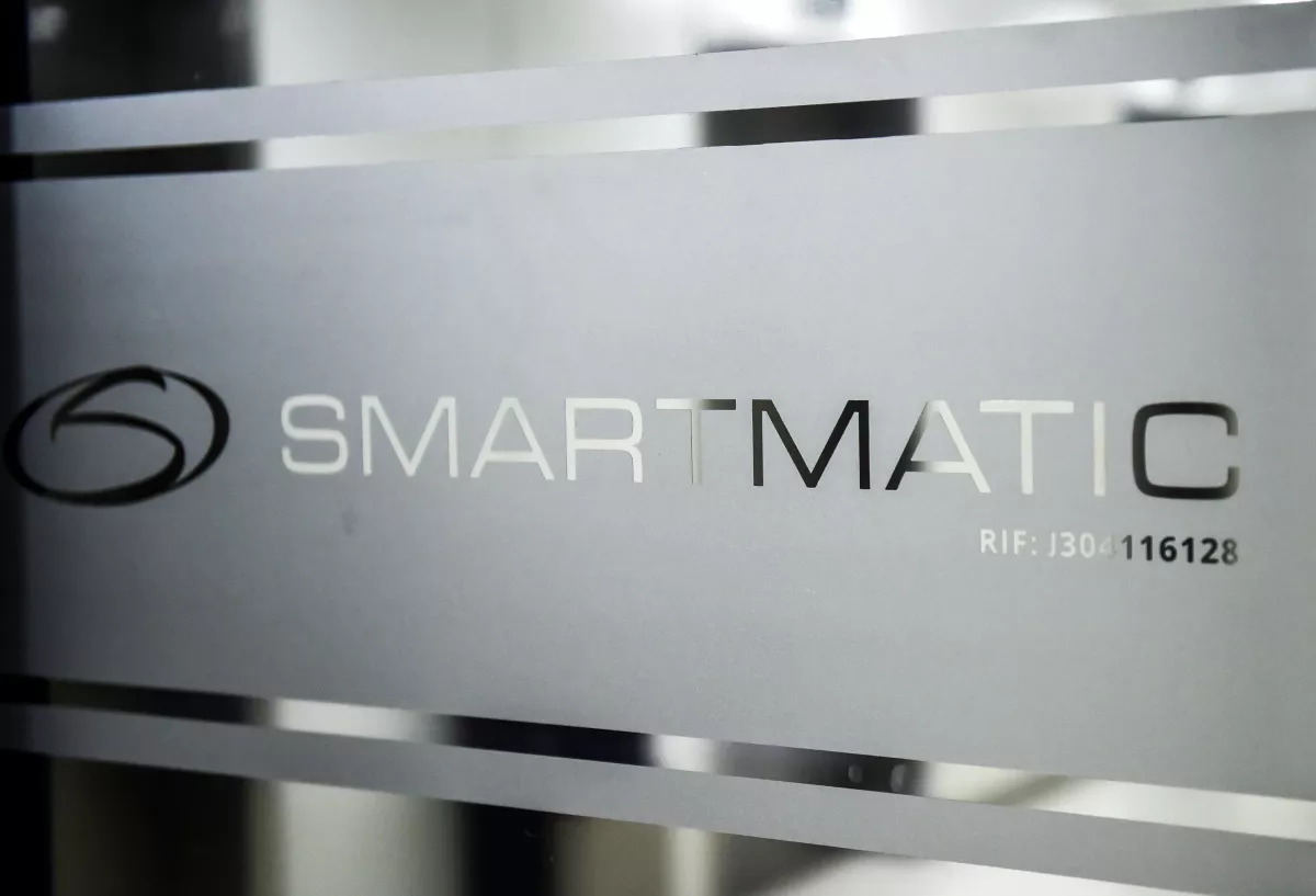The logo of Smartmatic, the firm that supplies Venezuela's voting technology, seen on a sliding door at the headquarters of the company in Caracas, on August 2, 2017.