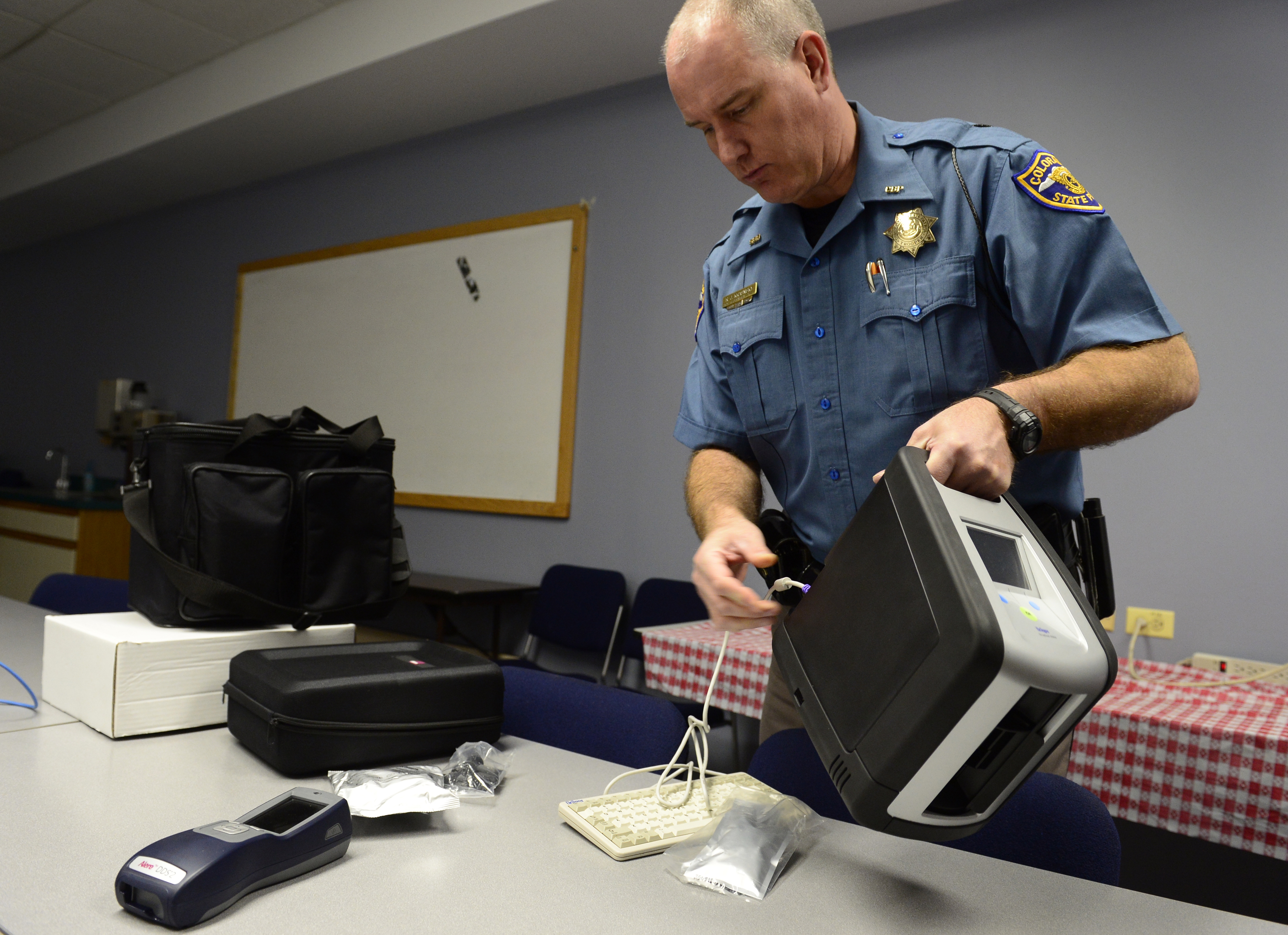 Colorado State Trooper Ron Krasnisky shows the department