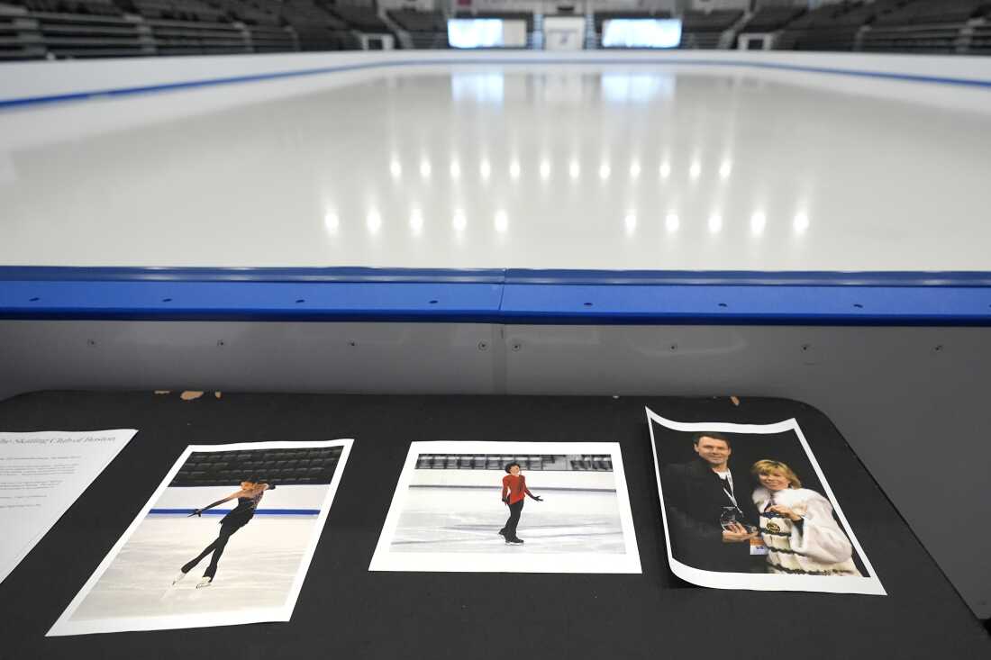 Photographs of aircraft crash victims from the Skating Club of Boston are displayed rink-side on Thursday in Norwood, Mass. From left: Skater Jinna Han, skater Spencer Lane and coaches Vadim Naumov and Evgenia Shishkova.