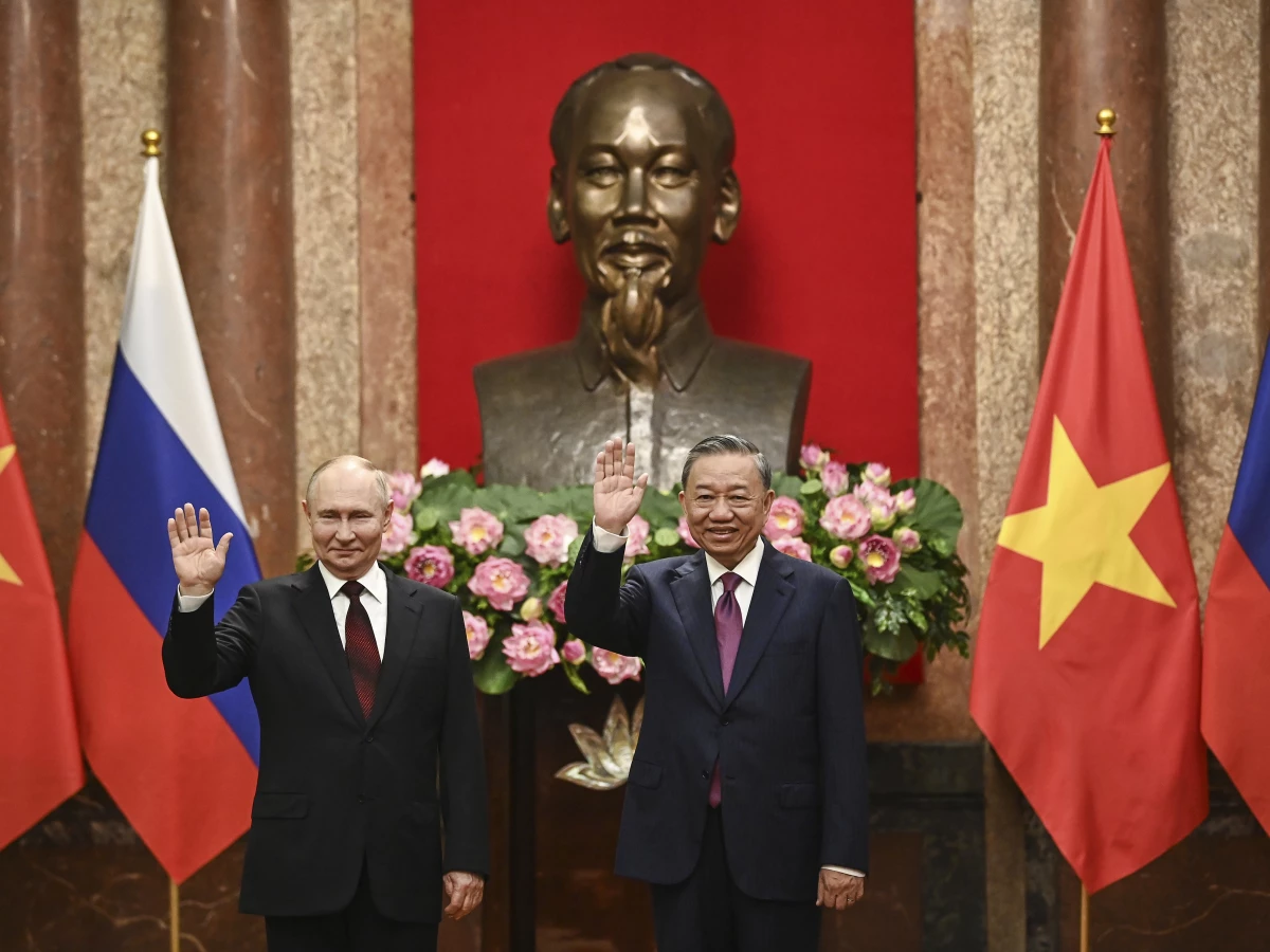 Russian President Vladimir Putin (left) and Vietnam's President To Lam pose for photos at the Presidential Palace in Hanoi, Vietnam, on Thursday.