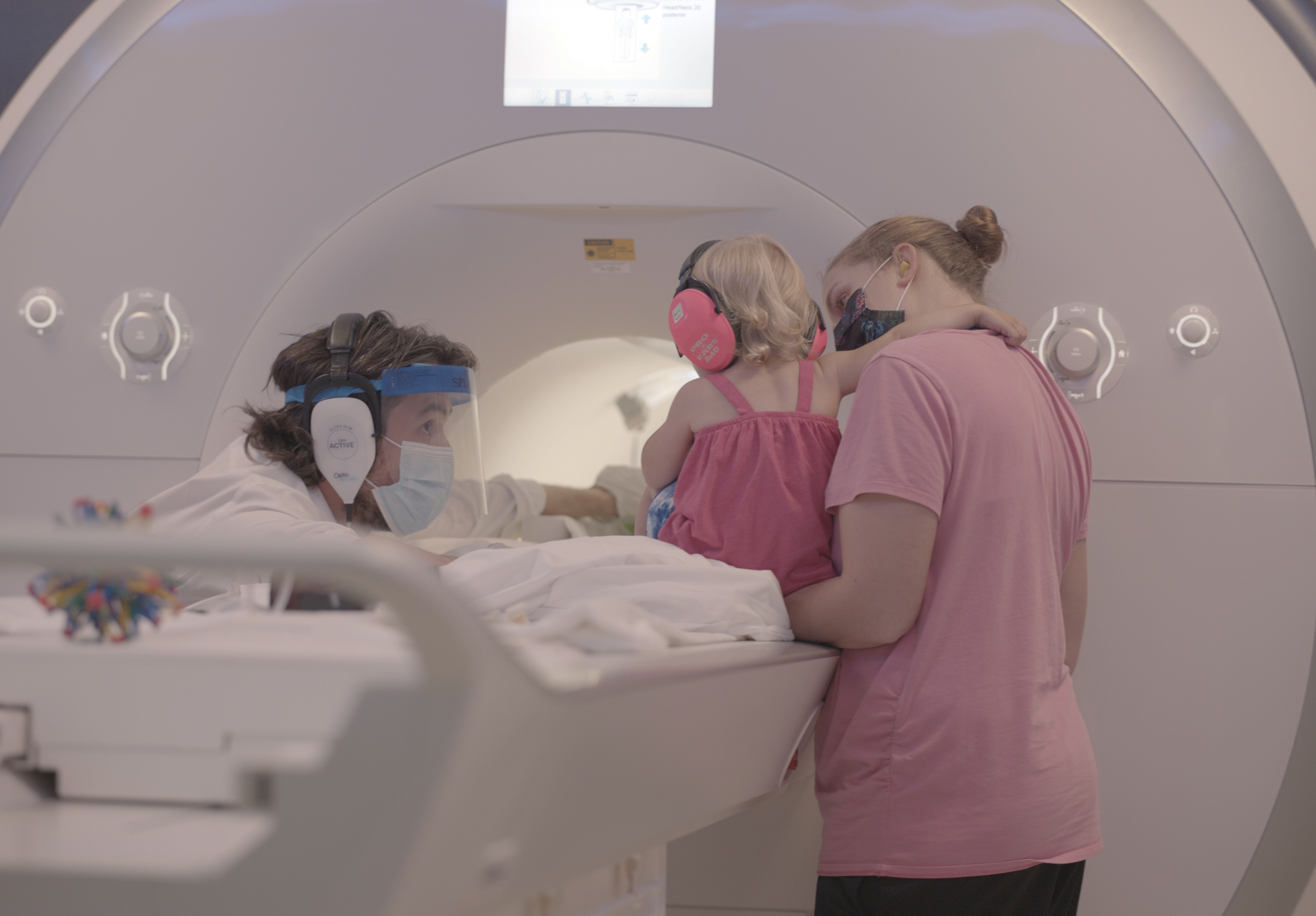 Yale cognitive neuroscientist Nick Turk-Browne works with a baby and parent during a brain scan.