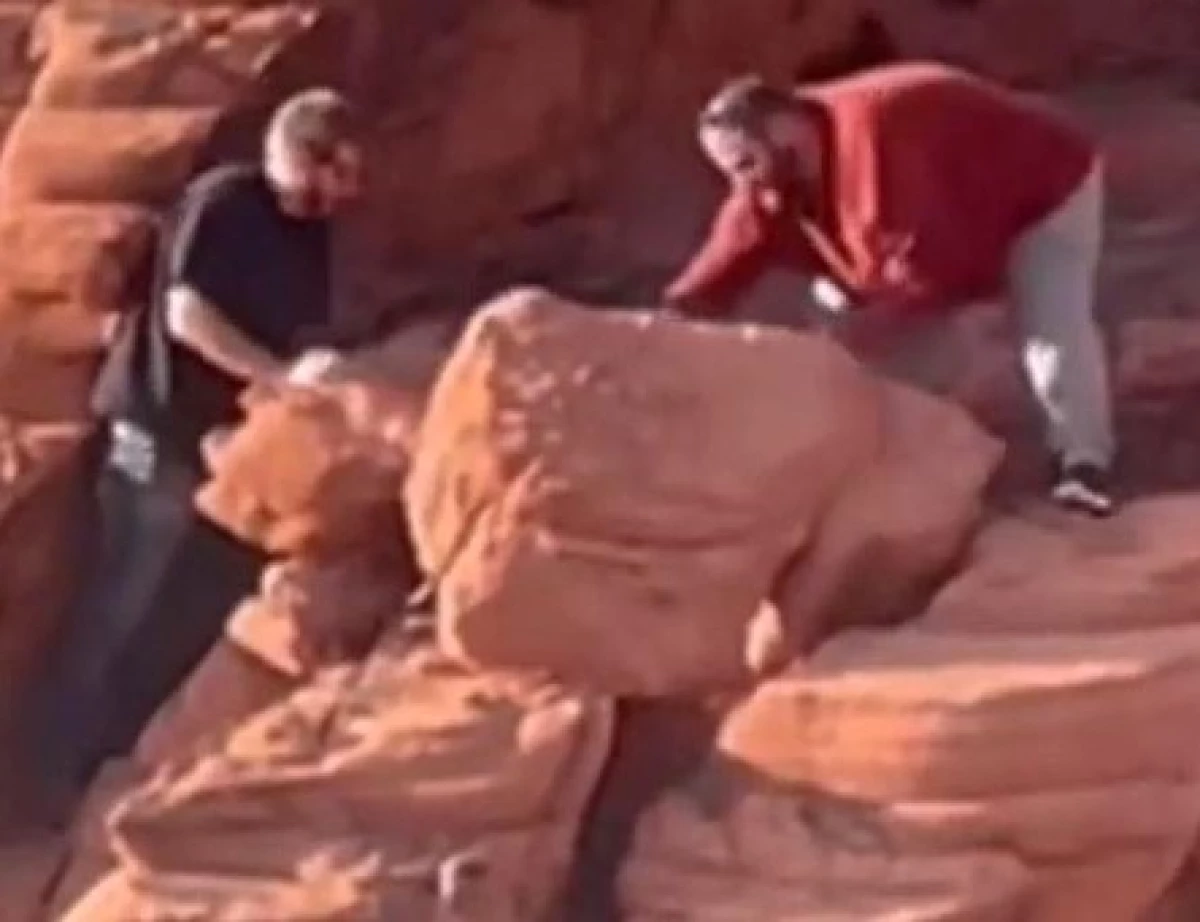 An image provided by the National Park Service shows two men who were caught on video in April toppling rock formations at Lake Mead National Recreation Area. A federal jury has indicted Wyatt Clifford Fain, 37, and Payden David Guy Cosper, 31, of Henderson, Nev.