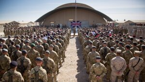 The United Kingdom's flag is displayed as British troops and service personnel in Afghanistan are joined by International Security Assistance Force personnel and civilians as they gather for a Remembrance Sunday service at Kandahar Airfield, Nov. 9, 2014, in Kandahar, Afghanistan.